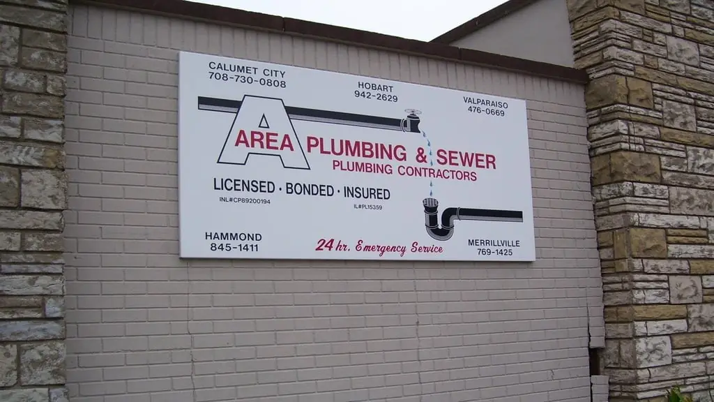 The Area Plumbing & Sewer shop sign at 7219 White Oak Ave in Hammond, Indiana, listing both state licence numbers